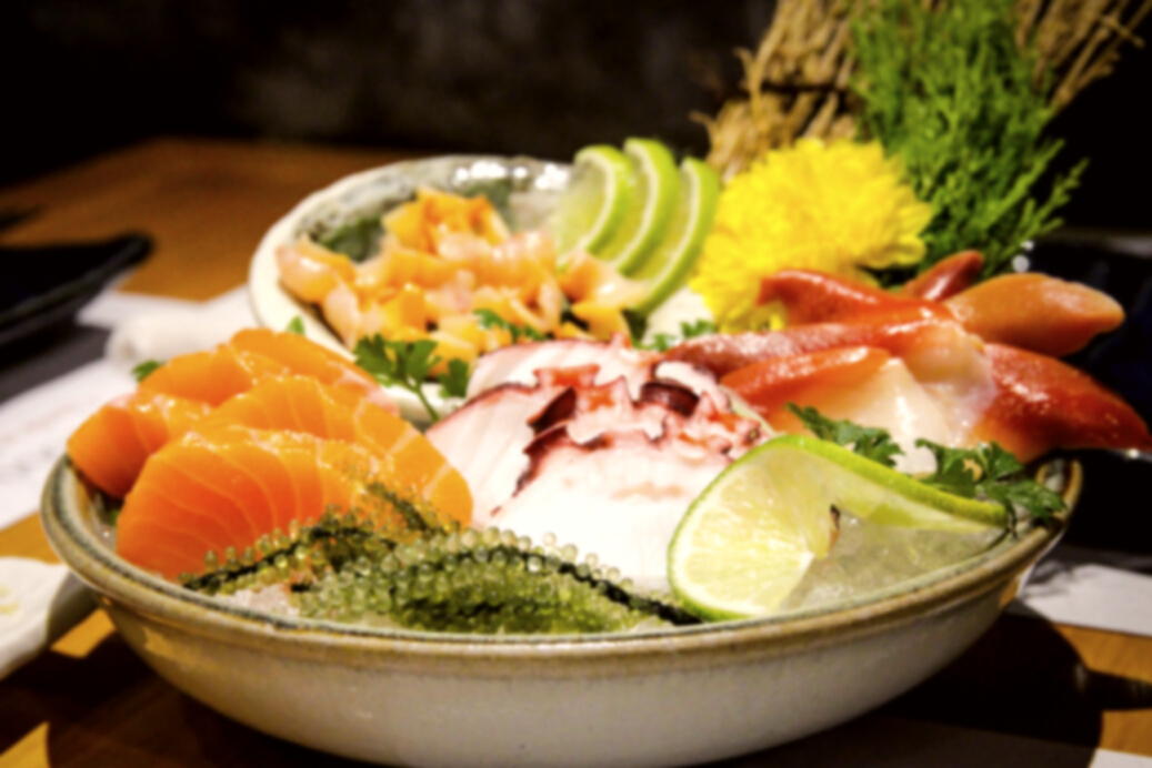 Served cold sashimi with herbs and condiments